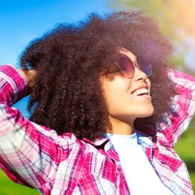 Woman outdoors in the sunshine finding joy in her life