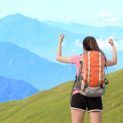 Woman with arms up. Power poses can help with aspirations to become more courageous