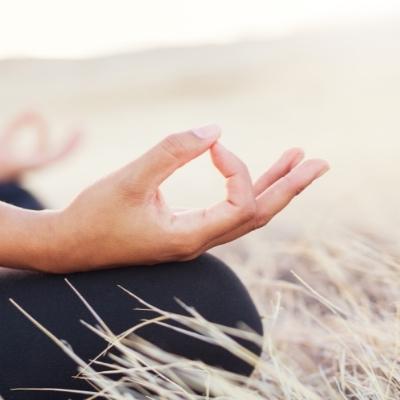 Woman's hands in mudra as she is meditating
