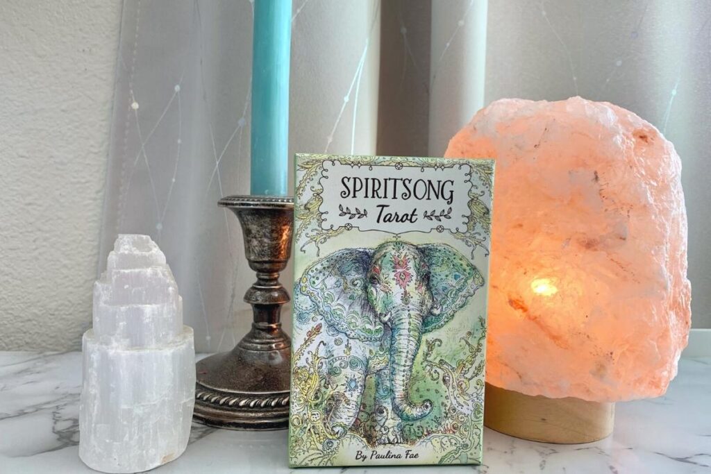 Spiritsong tarot with Himalayan Salt lamp, selenite tower, and candle