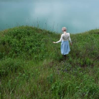 Woman in a field that is shaped like a yin yang for masculine and feminine energies