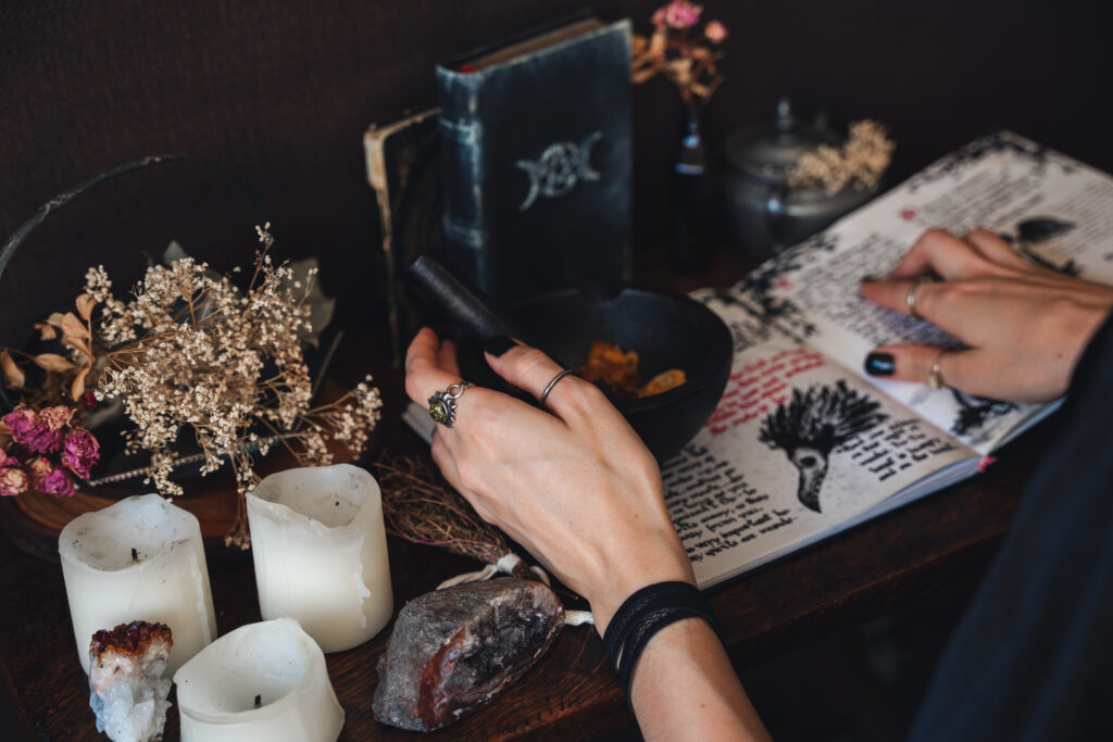 Witch at her altar. A witch is someone who... casts spells, sets intentions, and manifests her best life