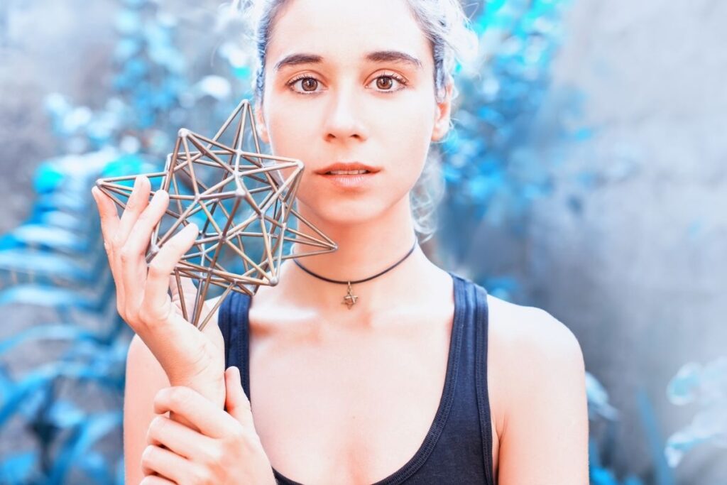 Lightworker witch posing with sacred geometry