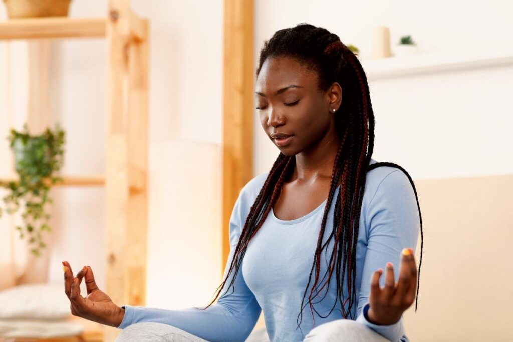 Woman practicing a meditation as part of her morning routine for spiritual growth