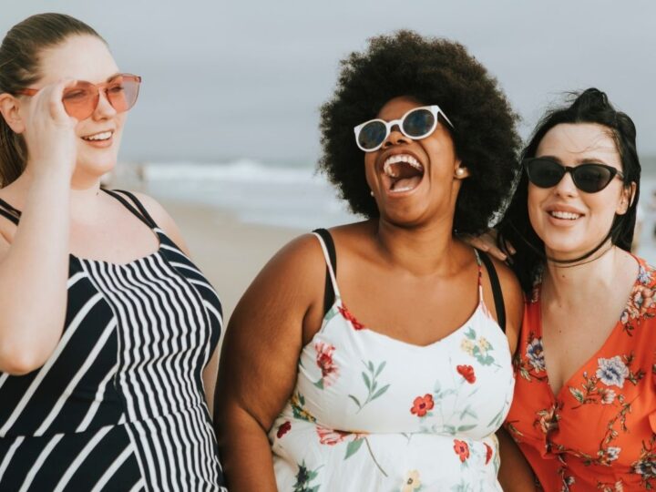 Women on the beach laughing and having fun, big personalities