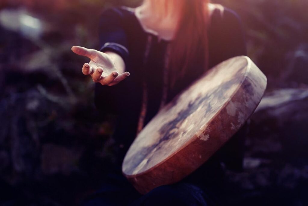 Life Visioning. Woman with shamanic drum extending a hand
