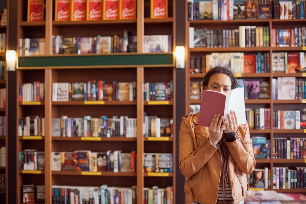 Person reading life-changing books for women in a second hand bookstore