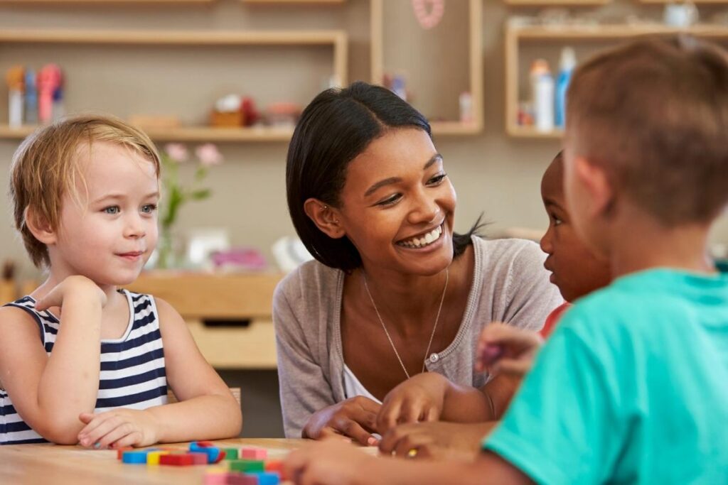 Teacher in a Montessori classroom with 3 students