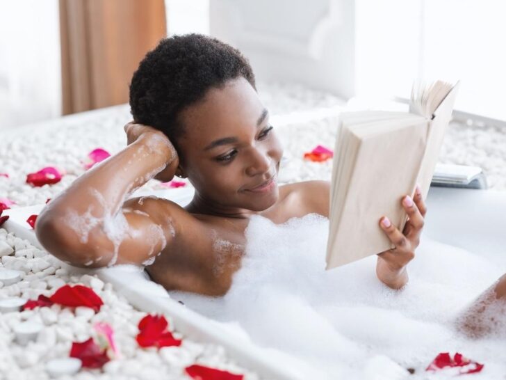 Woman reading a book on affirmations for self care