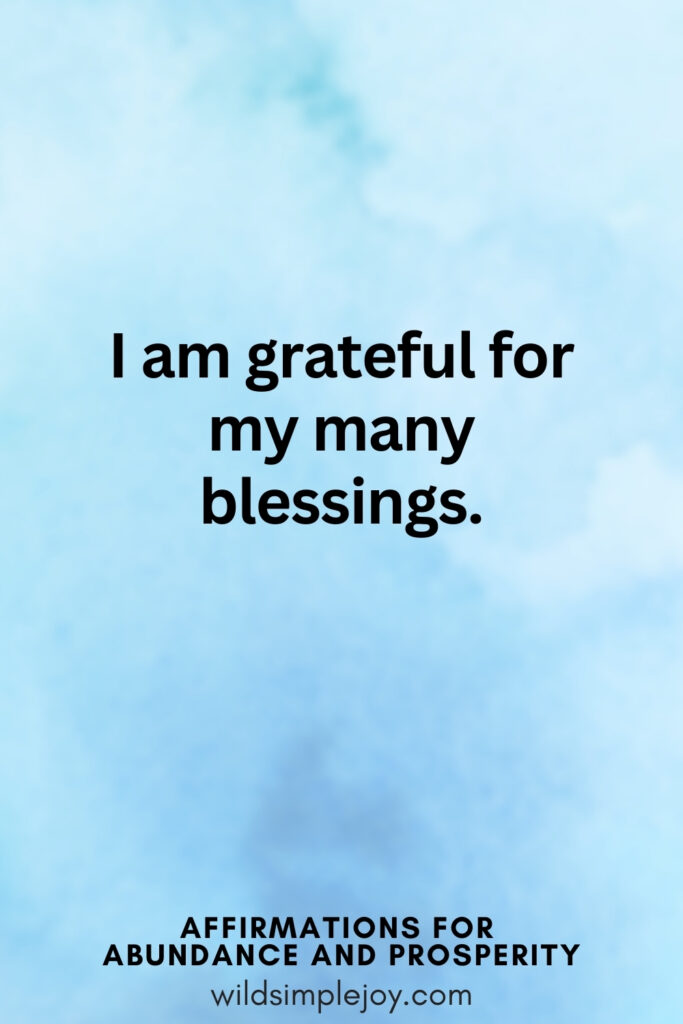 Vertical pin image with blue watercolor background and text overlay, I am grateful for my many blessings. Affirmations for Abundance and Prosperity