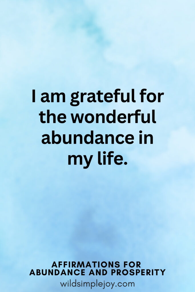 Vertical pin image with blue watercolor background and text overlay, I am grateful for the wonderful abundance in my life! Affirmations for Abundance and Prosperity