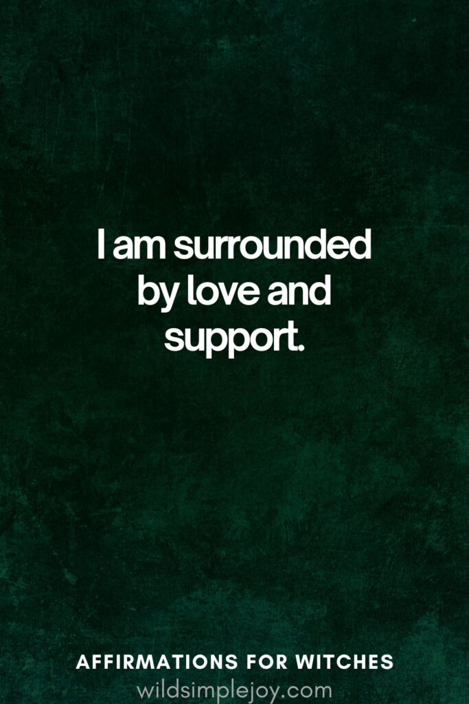 Vertical pin image with dark green background and text overlay, I am surrounded by love and support. Magickal Affirmations for Witches wildsimplejoy.com