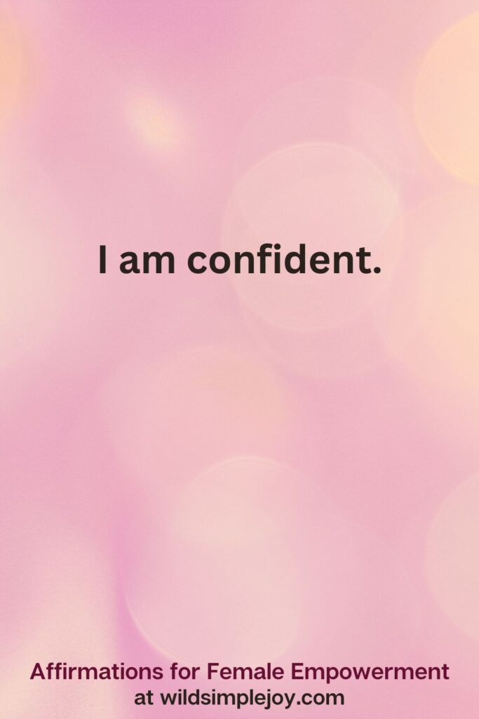 Vertical pin image with pink bokeh light background and text overlay, I am confident. Affirmations for Female Empowerment at wildsimplejoy.com