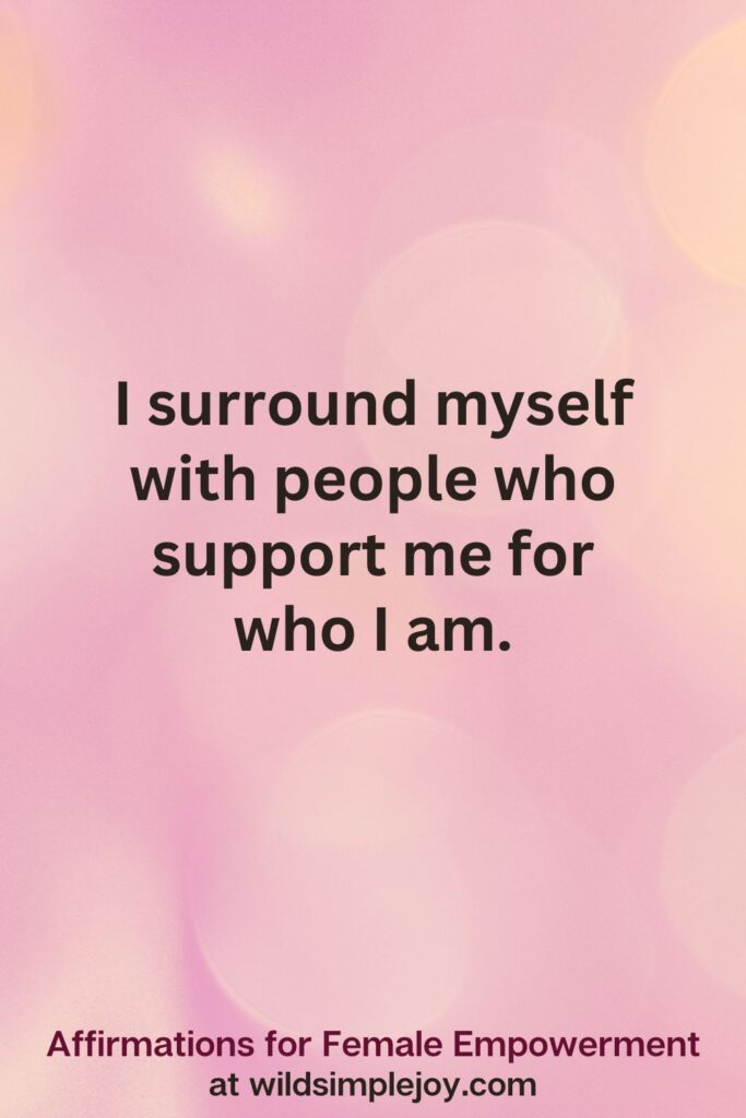 Vertical pin image with pink bokeh light background and text overlay, I surround myself with people who support me. Affirmations for Female Empowerment at wildsimplejoy.com