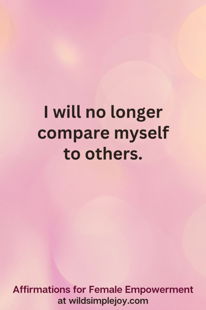 Vertical pin image with pink bokeh light background and text overlay, I will no longer compare myself to others. Affirmations for Female Empowerment at wildsimplejoy.com