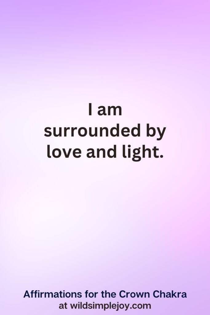 Vertical pin image with purple background and text overlay, I am surrounded by love and light. Crown Chakra Affirmations at wildsimplejoy.com