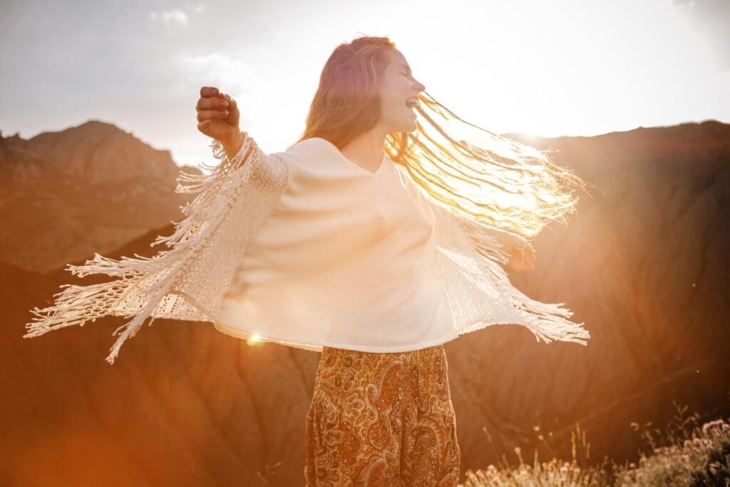 Woman spinning happily in the sunset