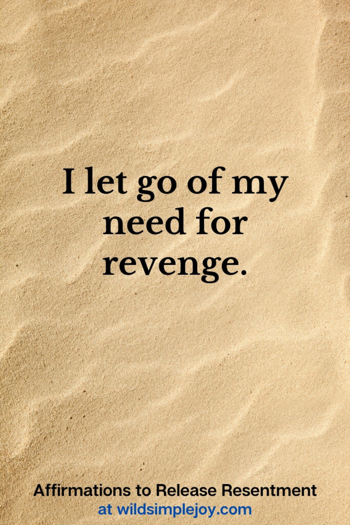 Vertical Pinterest Image with sand background and text overlay that reads I let go of my need for revenge Affirmations to release resentment at wildsimplejoy.com