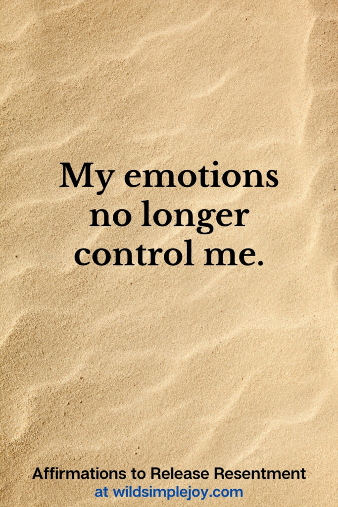 Vertical Pinterest Image with sand background and text overlay that reads My emotions no longer control me Affirmations to release resentment at wildsimplejoy.com