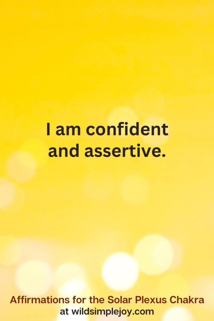 Vertical pin image with yellow background and text overlay that reads I am confident and assertive. Affirmations for the Solar Plexus Chakra at wildsimplejoy.com