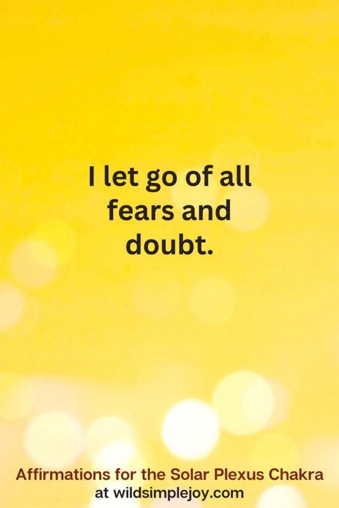 Vertical pin image with yellow background and text overlay that reads I let go of fears and doubts. Affirmations for the Solar Plexus Chakra at wildsimplejoy.com