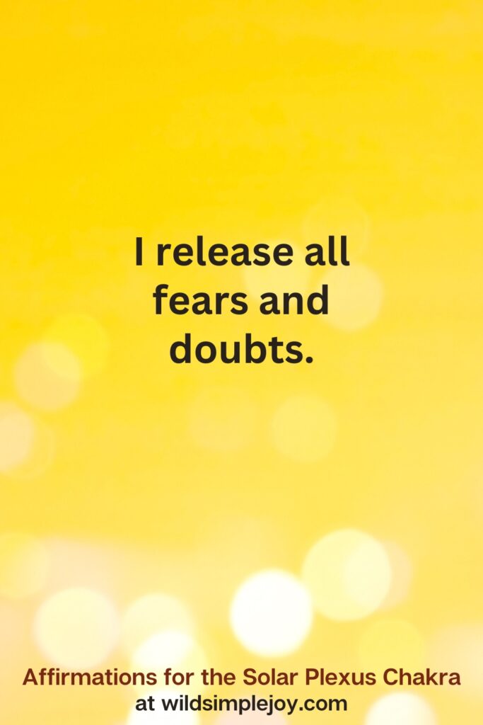 Vertical pin image with yellow background and text overlay that reads I release all fears and doubts. Affirmations for the Solar Plexus Chakra at wildsimplejoy.com