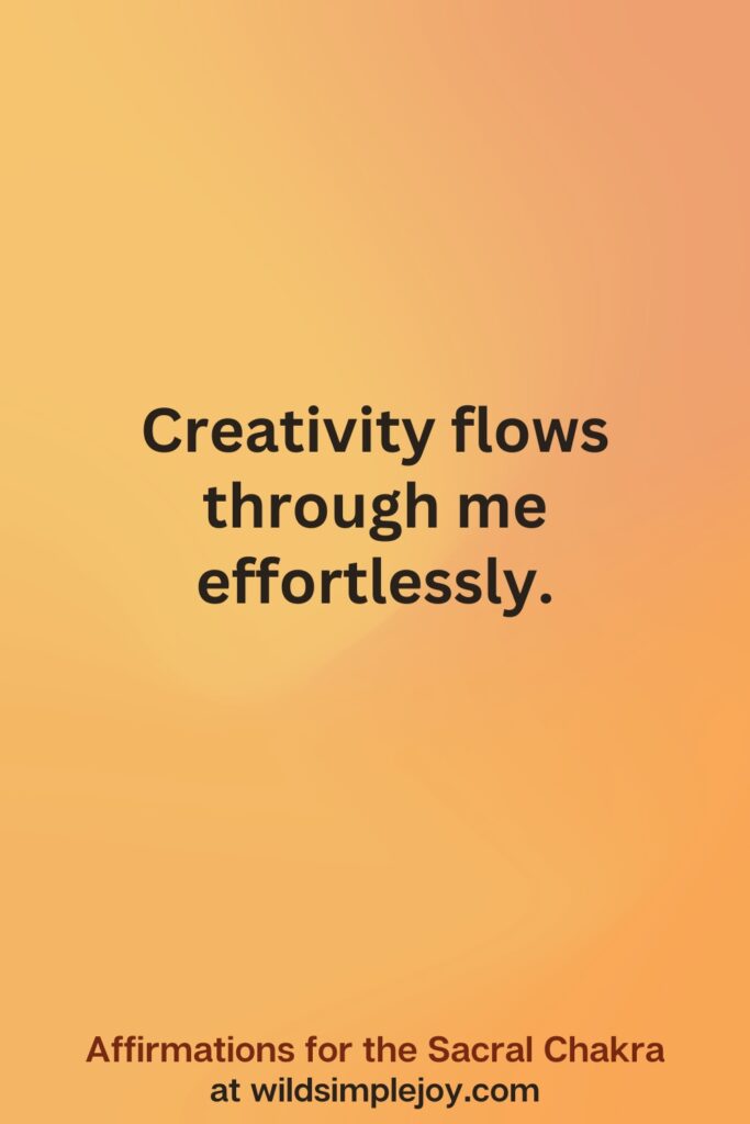 Vertical social media image on orange background with text overlay that reads Creativity flows through me effortlessly. Affirmations for the Sacral Chakra at wildsimplejoy.com