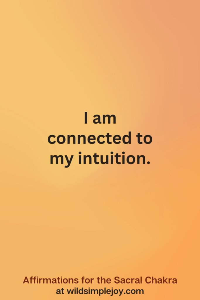 Vertical social media image on orange background with text overlay that reads I am connected to my intuition. Affirmations for the Sacral Chakra at wildsimplejoy.com