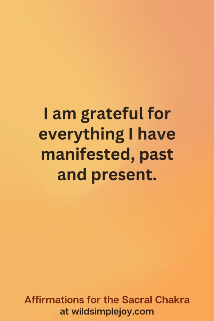 Vertical social media image on orange background with text overlay that reads I am grateful for everuthing I have manifested. Affirmations for the Sacral Chakra at wildsimplejoy.com