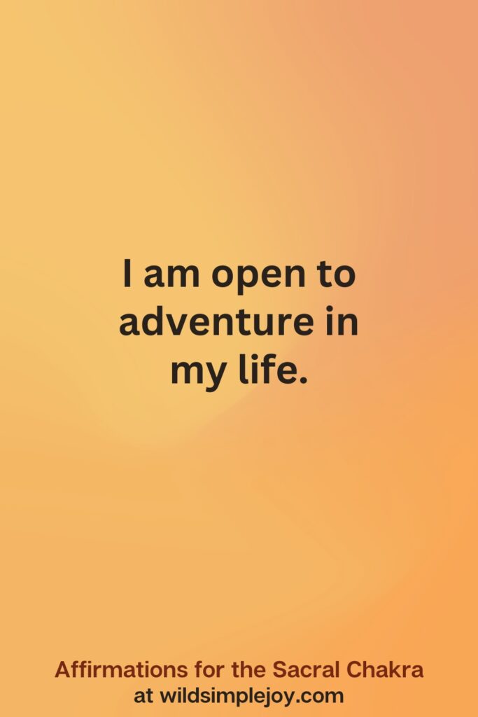 Vertical social media image on orange background with text overlay that reads I am open to adventure in my life. Affirmations for the Sacral Chakra at wildsimplejoy.com