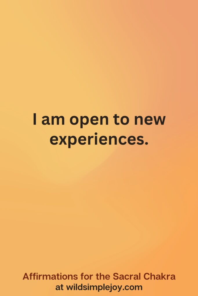 Vertical social media image on orange background with text overlay that reads I am open to new experiences. Affirmations for the Sacral Chakra at wildsimplejoy.com