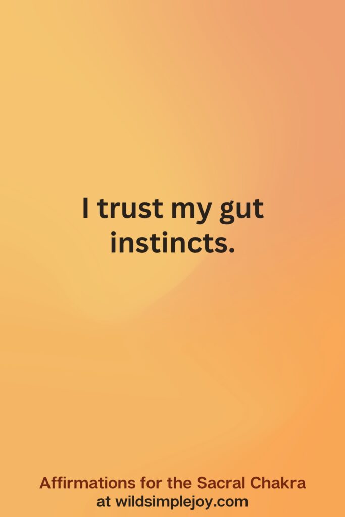 Vertical social media image on orange background with text overlay that reads I trust my gut instincts. Affirmations for the Sacral Chakra at wildsimplejoy.com