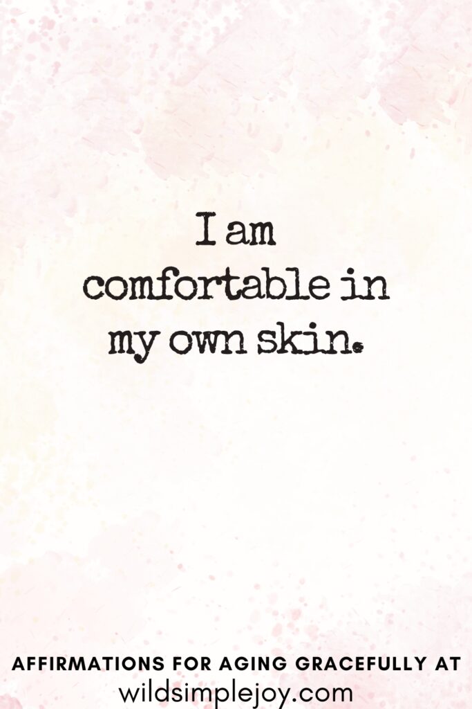 Vertical Pinterest Image on a pink background with text overlay I am comfortable in my own skin Affirmations for Aging Gracefully at wildsimplejoy.com