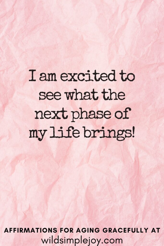 Vertical Pinterest Image on a pink background with text overlay I am excited to see what the next phase of my life brings Affirmations for Aging Gracefully at wildsimplejoy.com