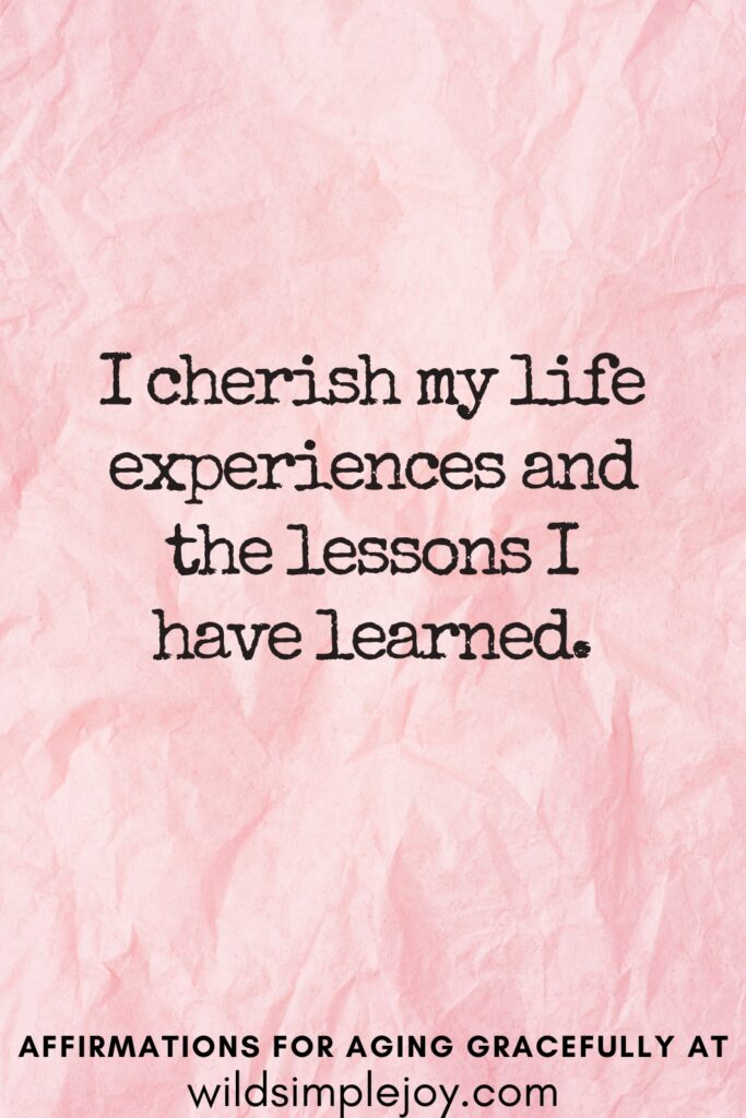 Vertical Pinterest Image on a pink background with text overlay I cherish my life experience and the lessons I have learned Affirmations for Aging Gracefully at wildsimplejoy.com