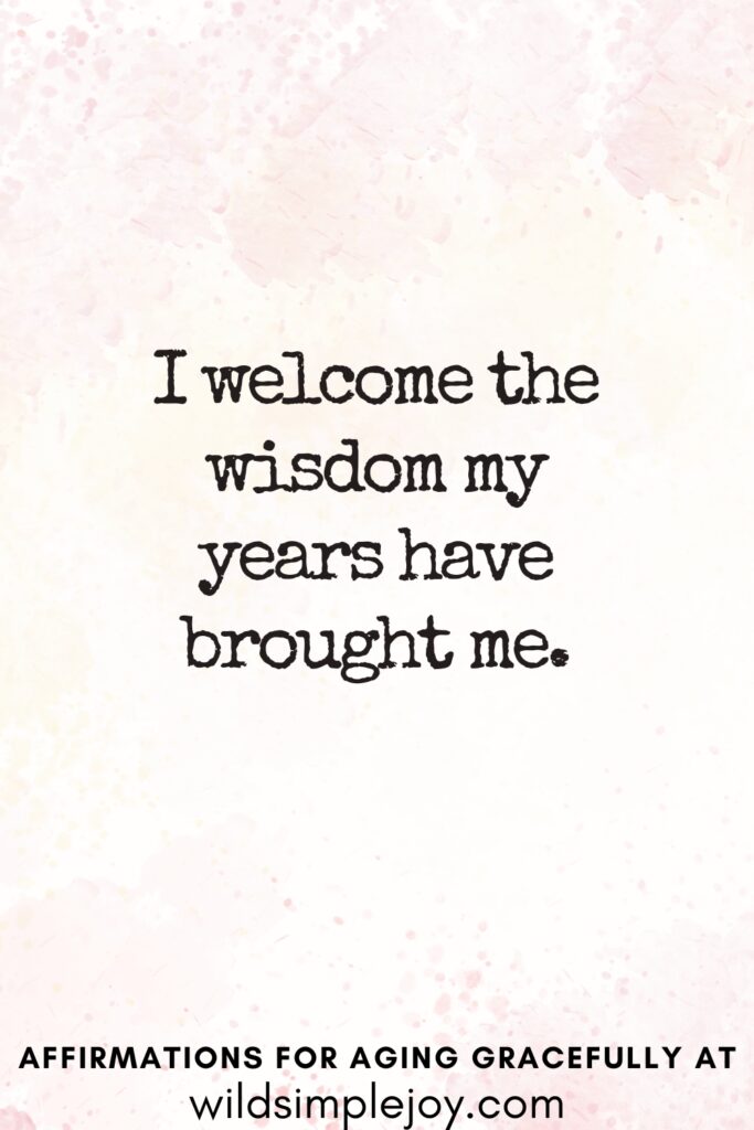 Vertical Pinterest Image on a pink background with text overlay I welcome the wisdom my years have brought me Affirmations for Aging Gracefully at wildsimplejoy.com