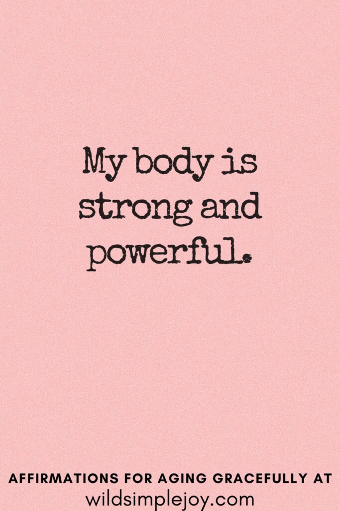 Vertical Pinterest Image on a pink background with text overlay My body is strong and powerful Affirmations for Aging Gracefully at wildsimplejoy.com