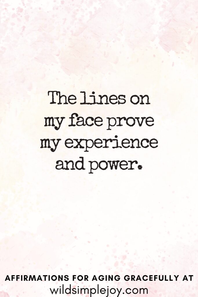 Vertical Pinterest Image on a pink background with text overlay The lines on my face prove my experience and power Affirmations for Aging Gracefully at wildsimplejoy.com