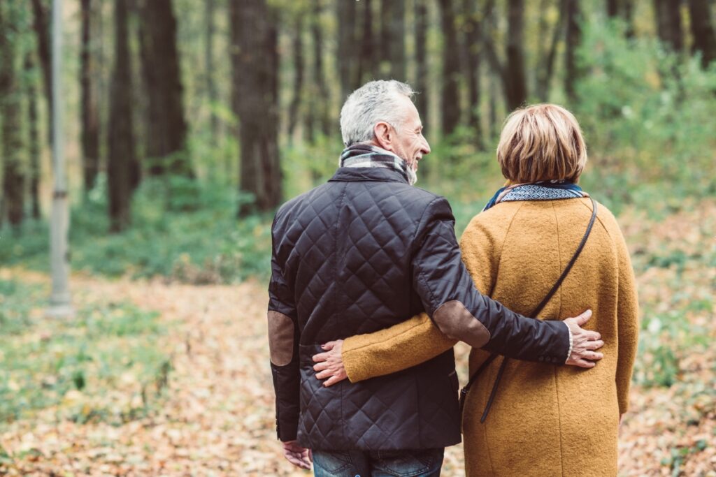 Boomer couple walking in the forest