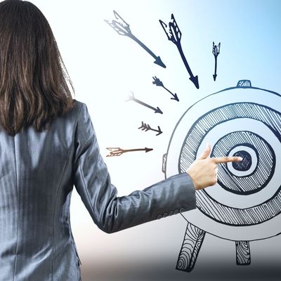 Woman pointing to bullseye target