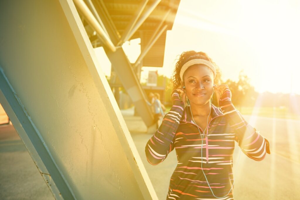 Woman exercising in urban area with sun beaming