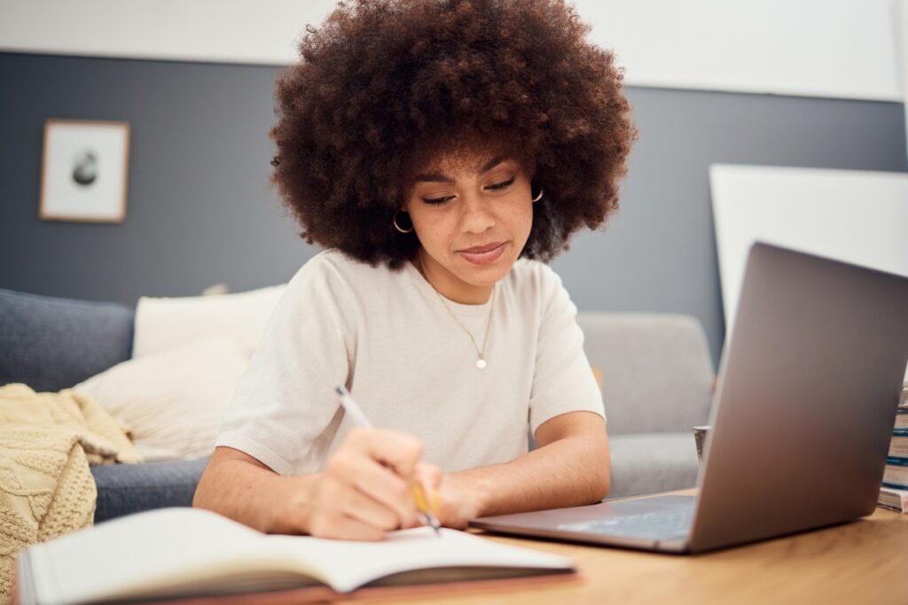 Woman writing in a journal at her desk