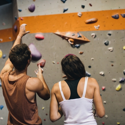 Man and woman sharing beta at the rock climbing gym