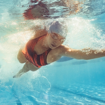 Woman swimming laps in a pool