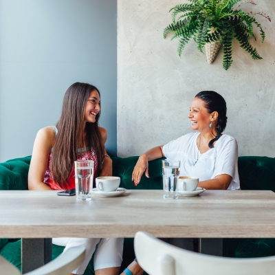 Two women talking on a couch