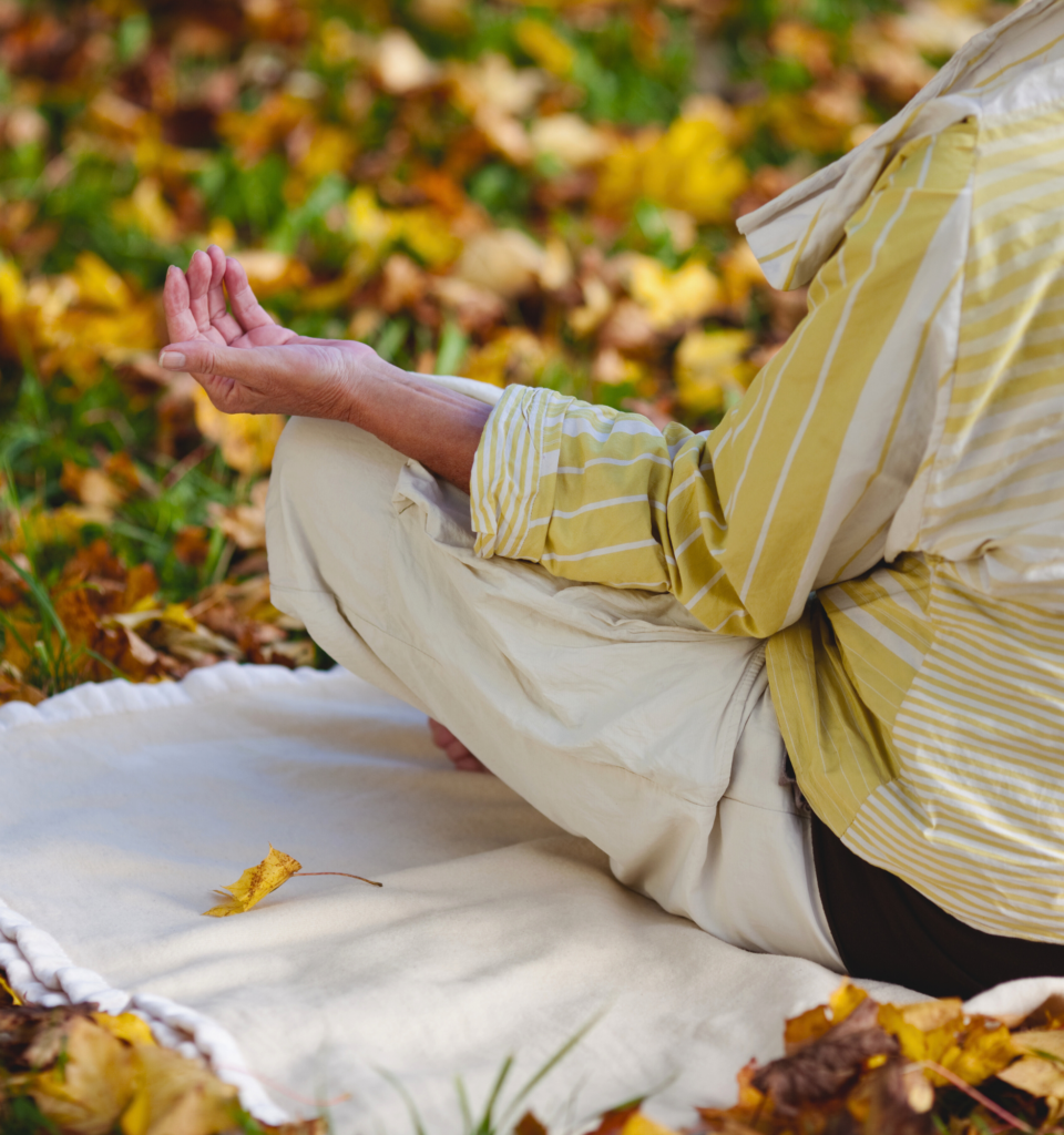 Woman meditating outdoors in autumn