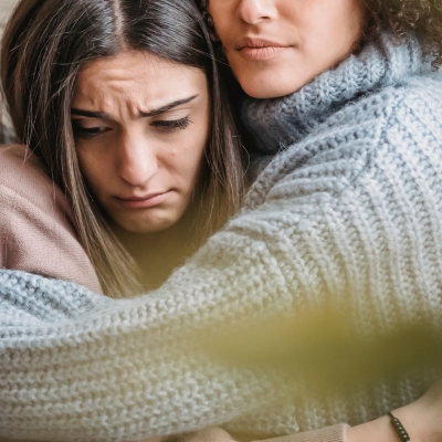 Compassionate woman hugging someone in pain