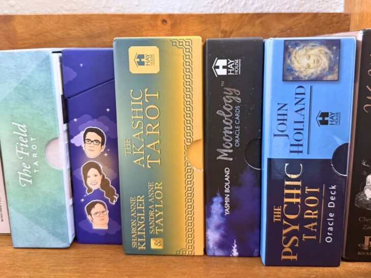 Tarot card decks on a bookshelf