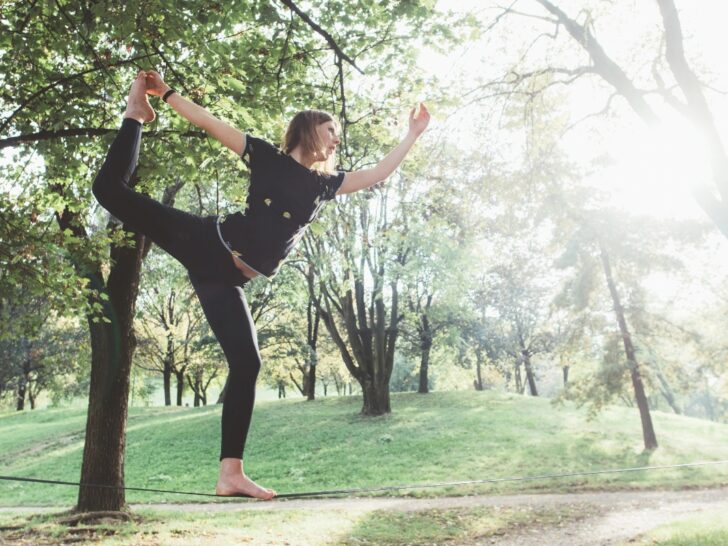 Woman balancing on a slackline in a park