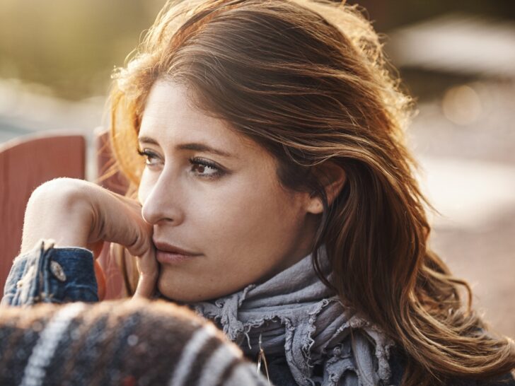 Woman looking pensive with sun on her face
